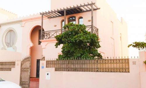 A pink house is for sale in Al Areen with a big garden.