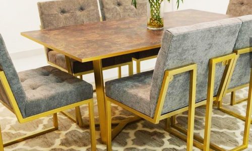 A Saar dining table with gray chairs and a rug.