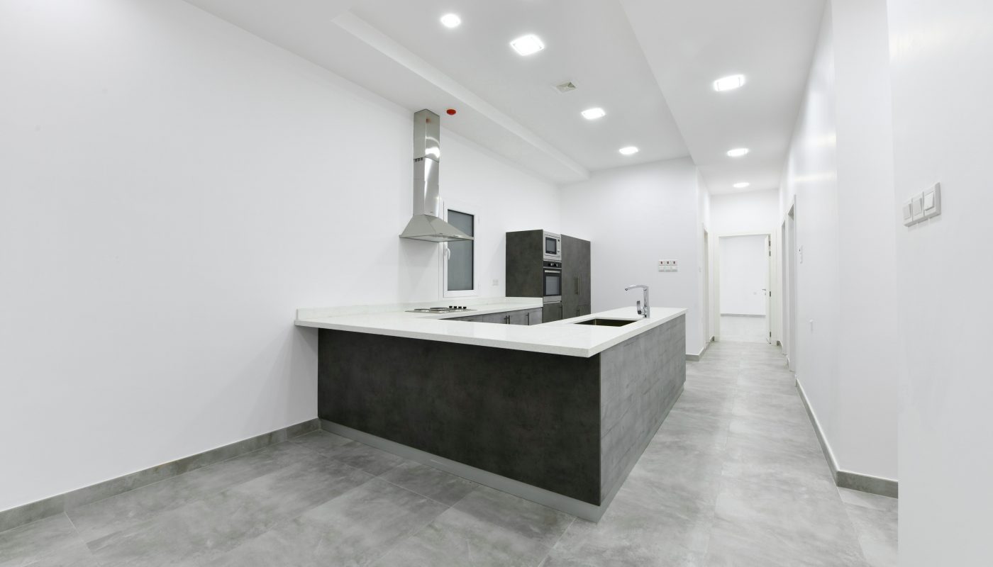 A luxurious apartment for sale, featuring an empty kitchen in a modern setting.