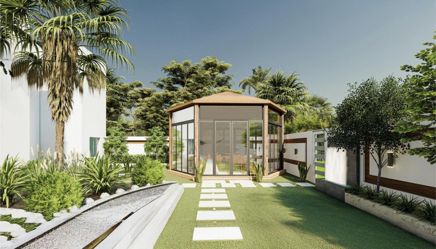 A modern glass-walled gazebo sits at the end of a stone pathway, surrounded by green lawn, trees, and a shallow water feature.