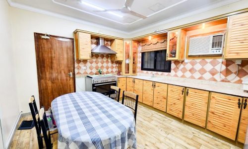 A luxury villa with wooden cabinets and a checkered tablecloth.