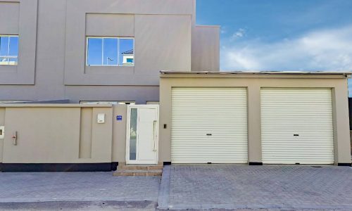 A luxurious 4BR villa located in Al Shakhura with two garages and a garage door.