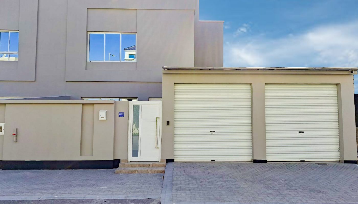 A luxurious 4BR villa located in Al Shakhura with two garages and a garage door.