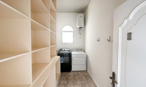 A spacious villa with a laundry room equipped with a washer and dryer.