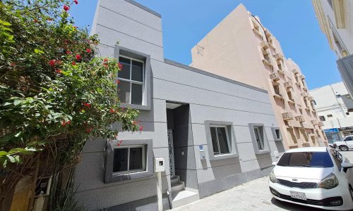 A car is parked in front of a building.