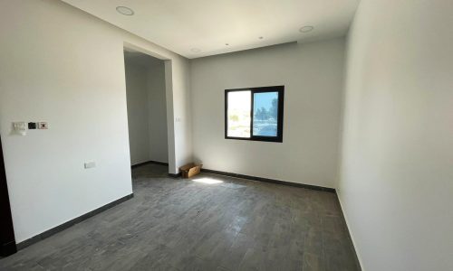 A bright room with wooden floors and a window.