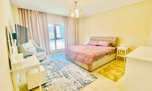 A modern bedroom with a bed and a bedside table in a flat.