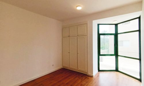 A vacant villa with wood floors and a sliding door.