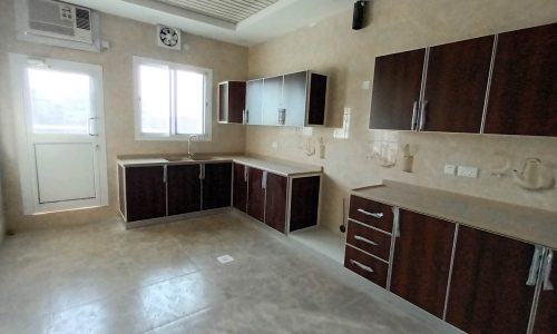 A deluxe kitchen with wooden cabinets and a ceiling fan.