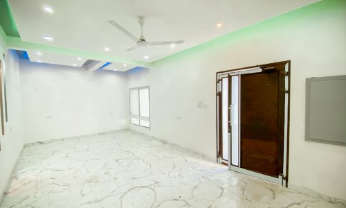 An empty room with white walls and a ceiling fan in a luxury 4BR villa.