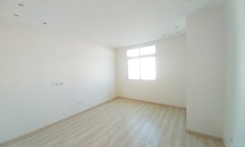 A Sanad apartment with 3 bedrooms, featuring white walls and wooden floors.