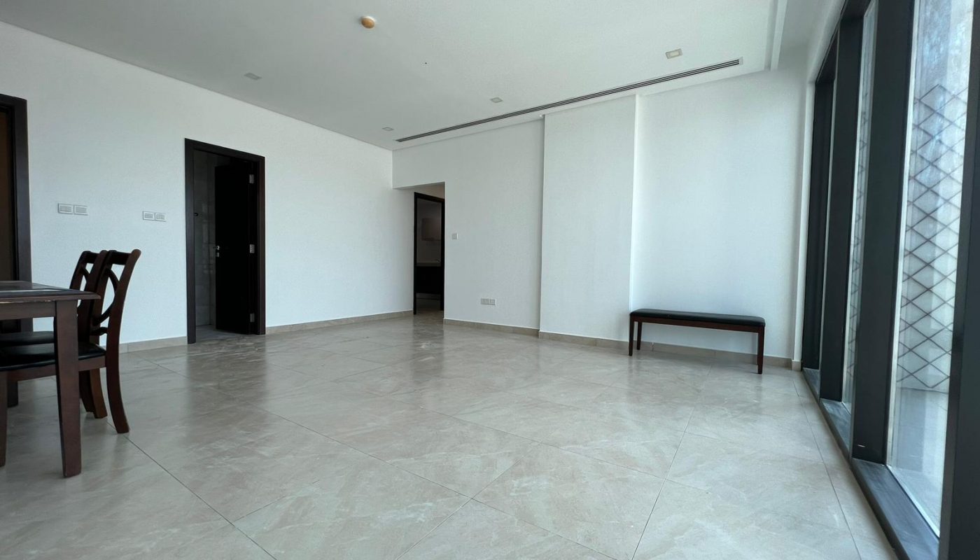 A luxurious apartment with large windows and a spacious dining table.