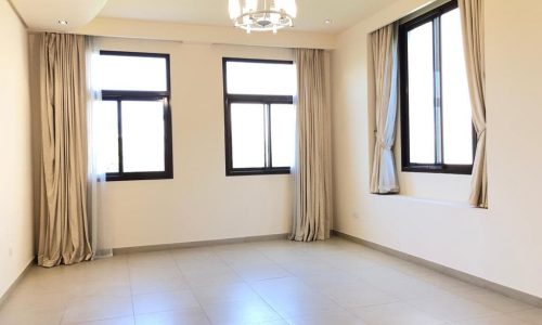 Al Jasra Rent offers a luxury villa with an empty room boasting large windows and a tiled floor.