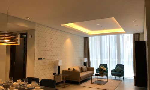 Modern living room and dining area in a luxury apartment.