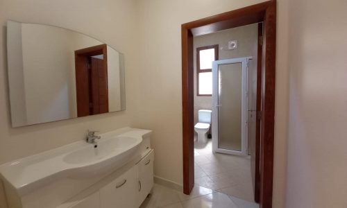 A bathroom with a mirror and sink.