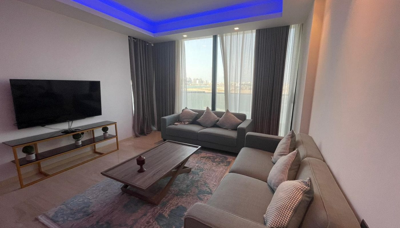 An elegant FF apartment with a flat screen TV and a view of Dilmunia Island's water.