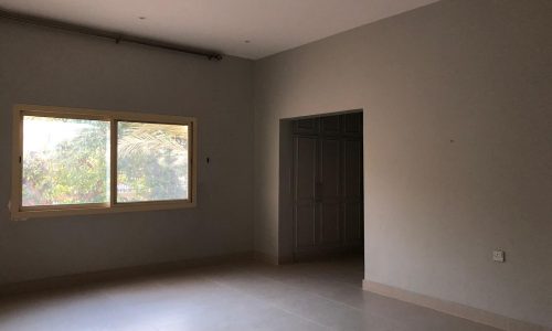 A room with a window and a tile floor.