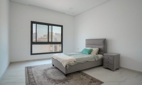 Spacious bedroom with a bed and a window in a Great Location.