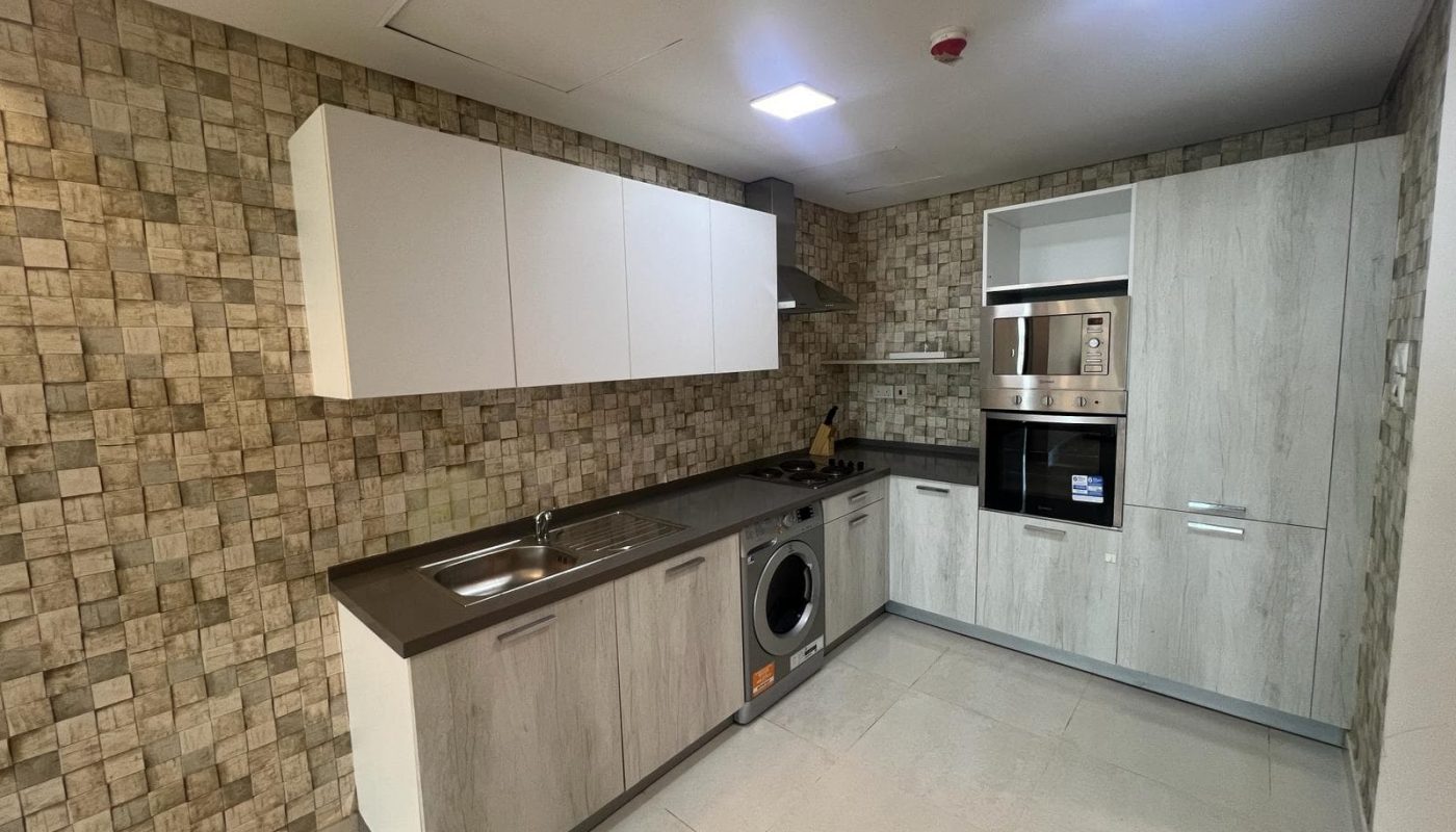 A kitchen with a washer and dryer in it.