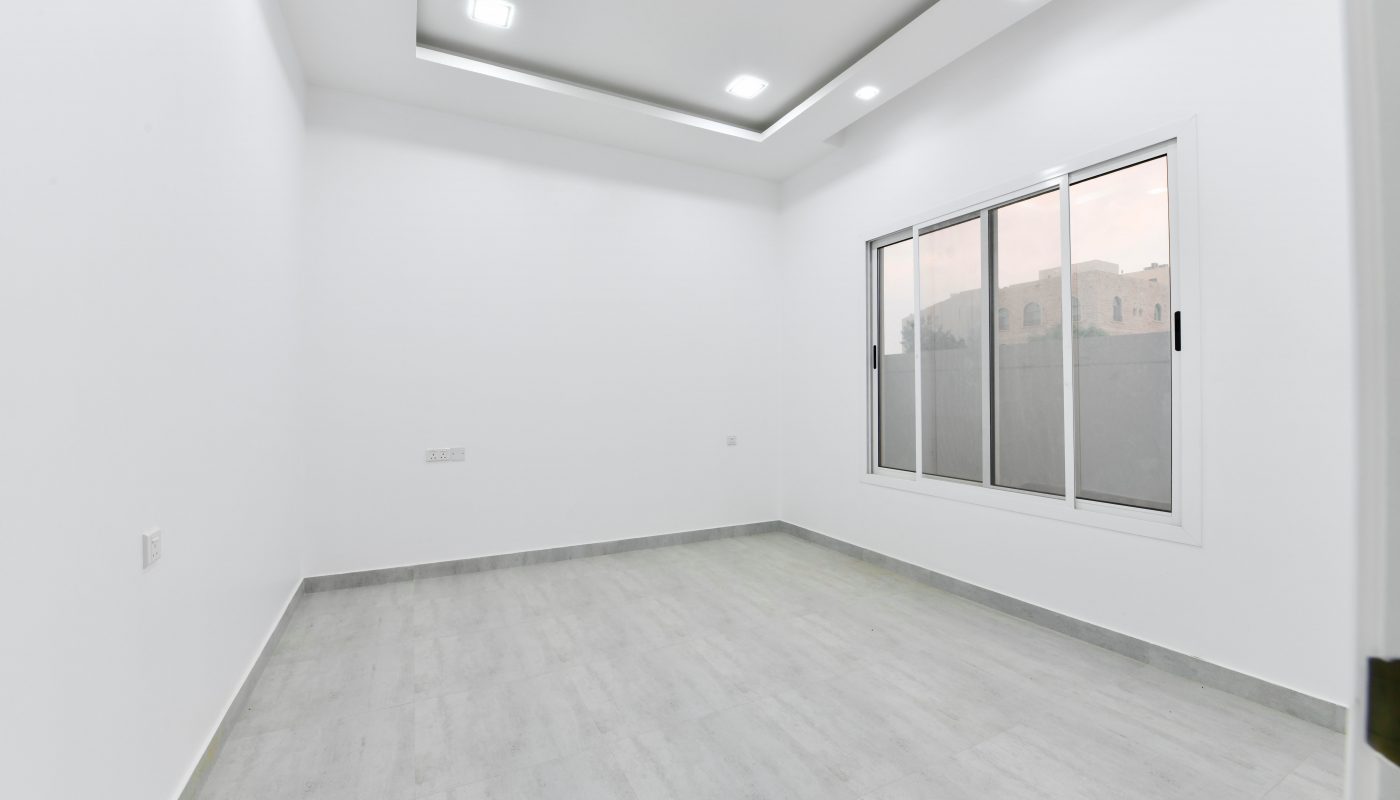 A luxurious apartment for sale, featuring an empty room with white walls and wooden floors at St. Christopher's School.