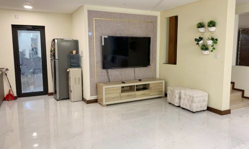 An amazing living room with a TV and a TV stand.