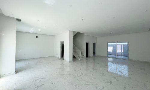 An amazing new villa with marble floors and a sliding glass door.