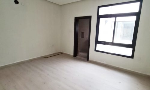 Brand New | Empty room with wooden floors and a window in a Villa for Sale in Barbar.