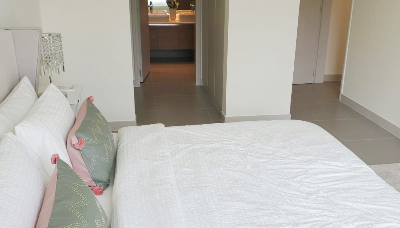 An apartment in Marassi available for rent, featuring a white bed in the bedroom.