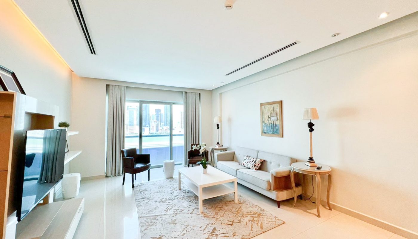 A luxury living room with a flat screen tv and a coffee table.