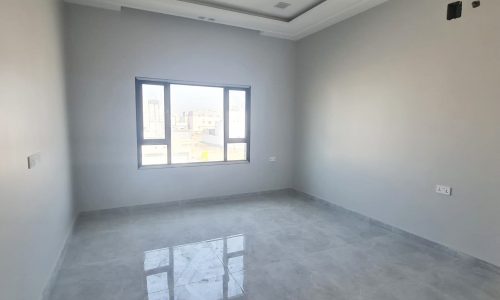 A room with a white floor and a window is available for sale.