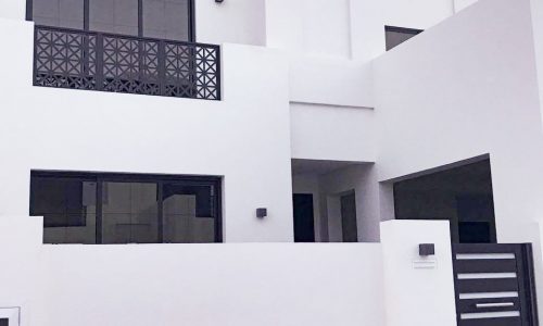 Stunning white house with a black fence and gate.