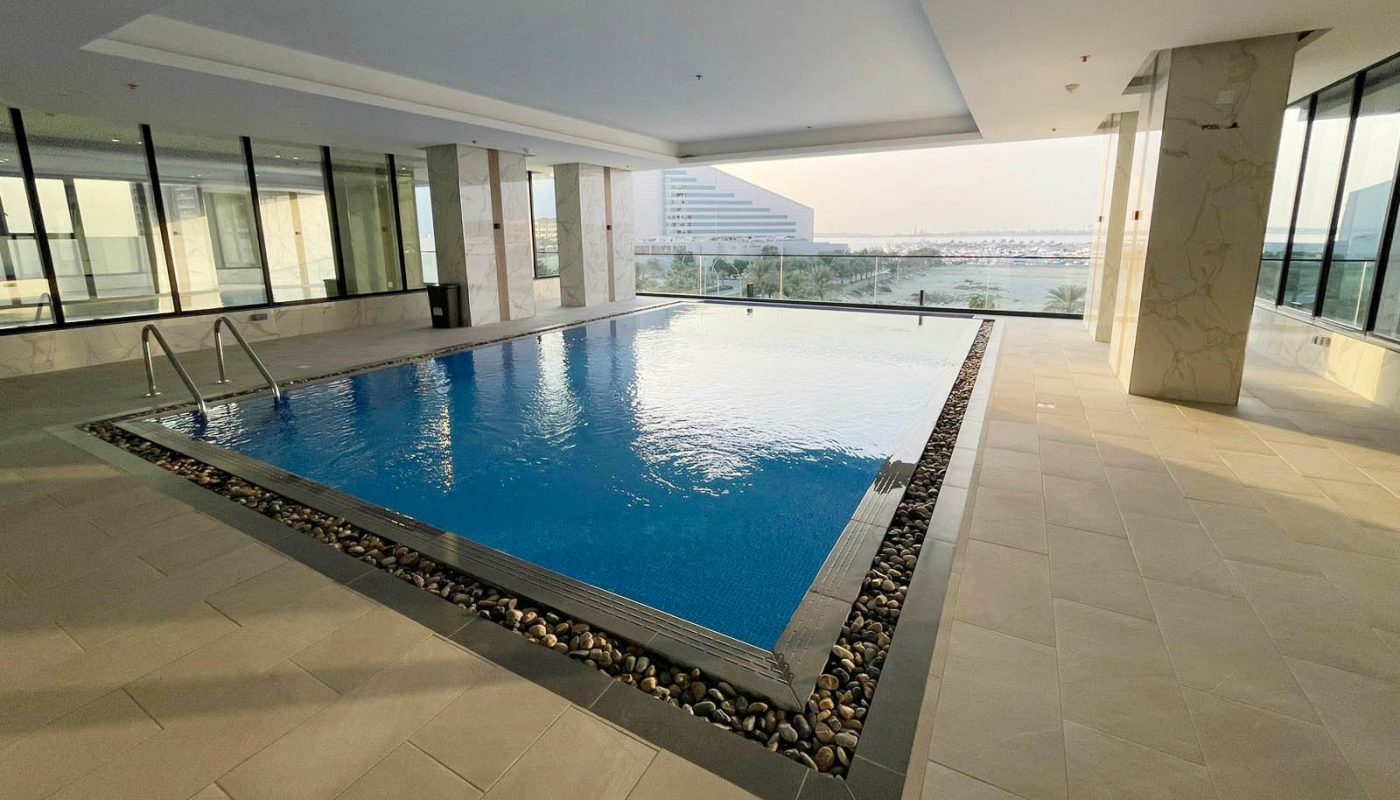 A large building with a swimming pool and a view.