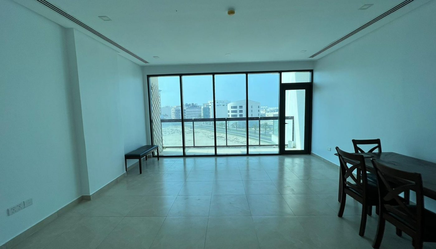 A luxurious apartment with a living room featuring a dining table and a stunning view of the city.