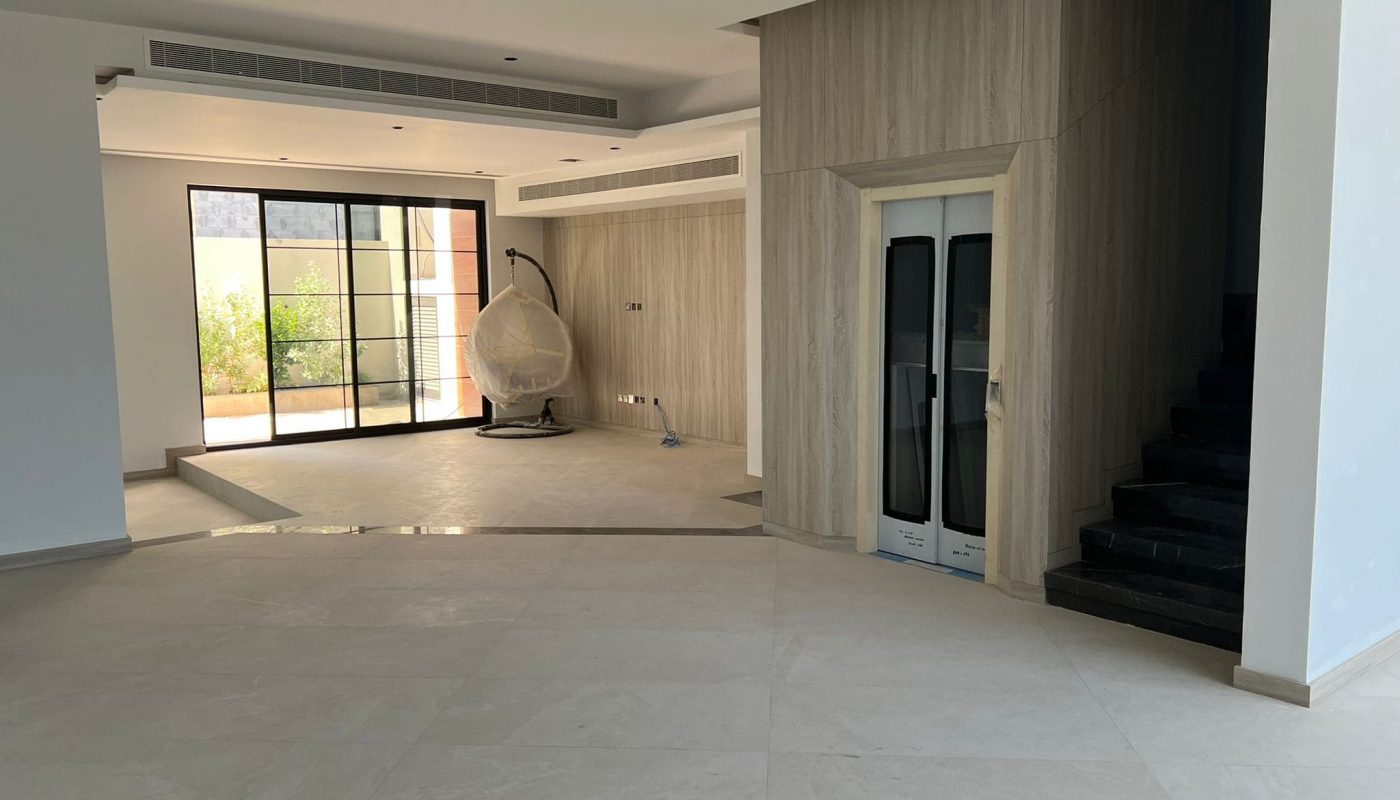 A huge empty room with glass doors in a luxury villa.