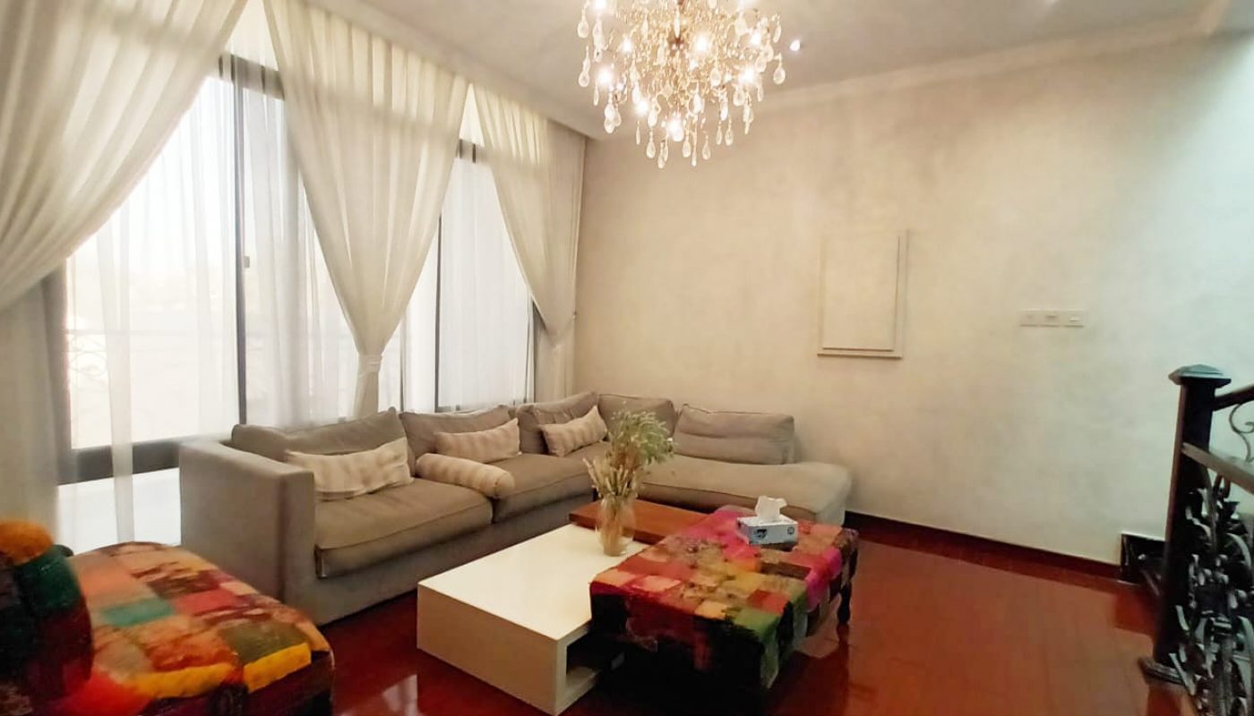 An amazing living room with modern couches and a stunning chandelier.