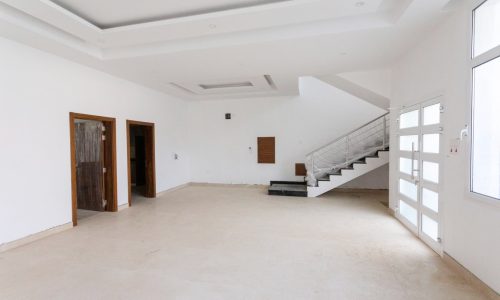 A spacious empty room with white walls.