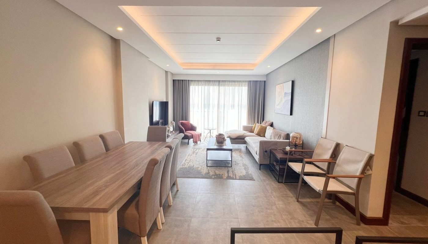 A luxurious flat in Hidd Heights featuring a living room with a dining table and chairs.