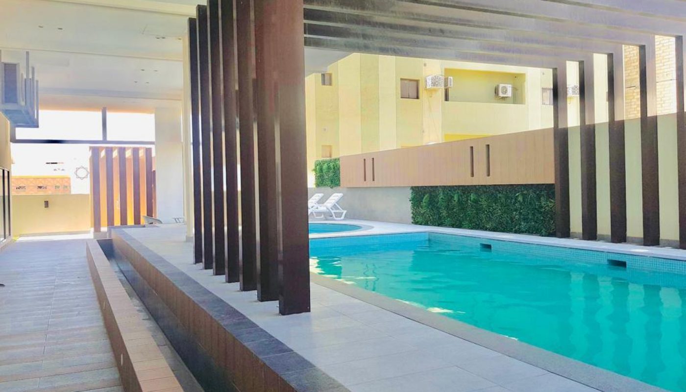 A luxury apartment with a swimming pool in the middle of the building, available for sale.