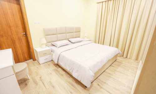 Keywords: bedroom, white bed, wooden floors.

Description: A bedroom with a stylish white bed and beautifully crafted wooden floors.