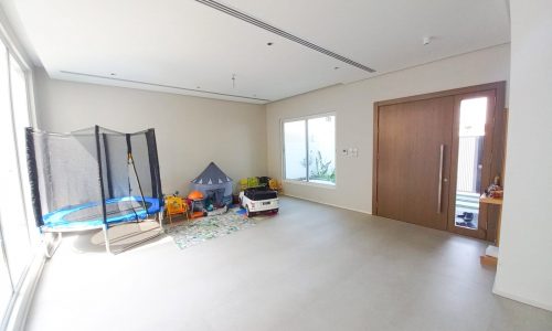 A luxury playroom with a huge trampoline.