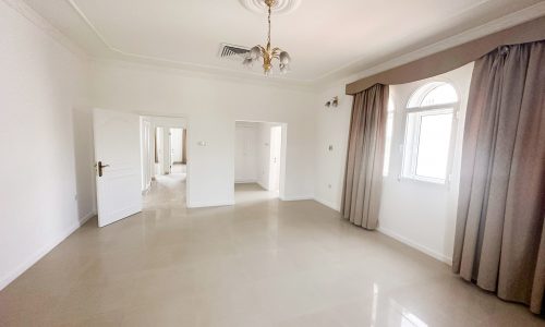 A vacant villa with white walls and beige floors available for rent.