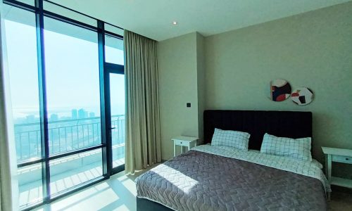 Luxurious apartment with a breathtaking view of the city available for rent in Seef. The bedroom features a spacious bed, perfect for ultimate comfort and relaxation.