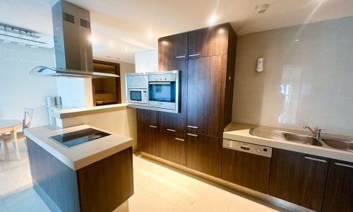 A luxury kitchen with wooden cabinets and stainless steel appliances.