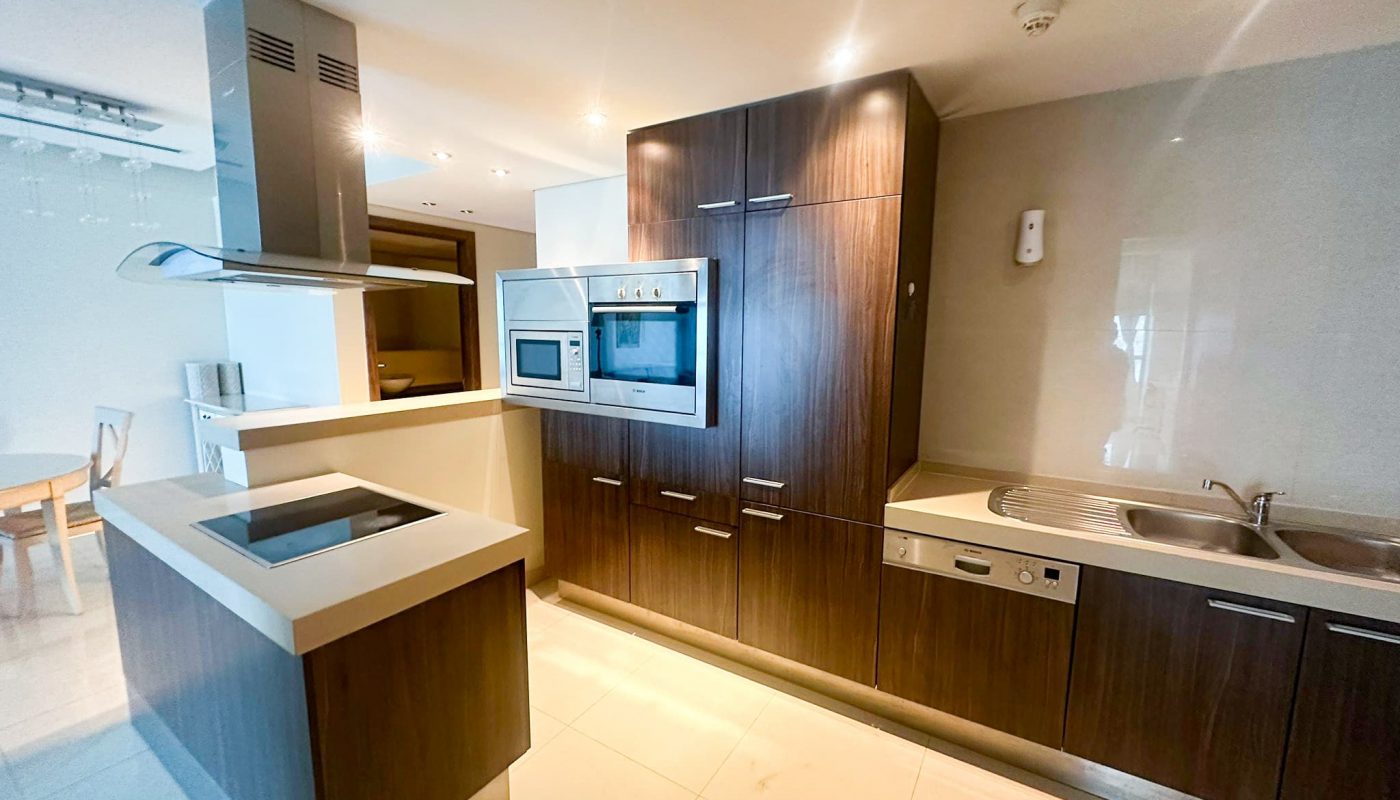 A luxury kitchen with wooden cabinets and stainless steel appliances.