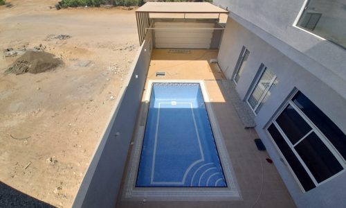 Amazing aerial view of a swimming pool in a house.