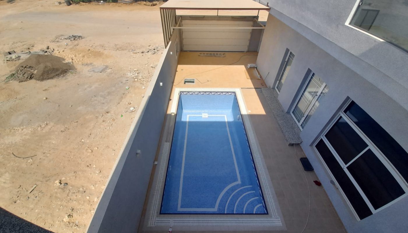Amazing aerial view of a swimming pool in a house.