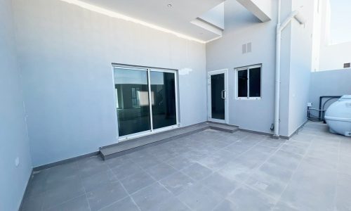 A house with a large patio and a water heater in Durrat Al Muharraq.