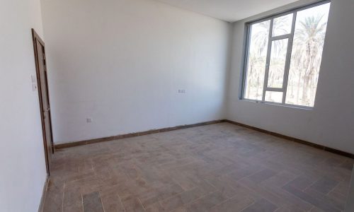 A charming room with wooden floors and a window.