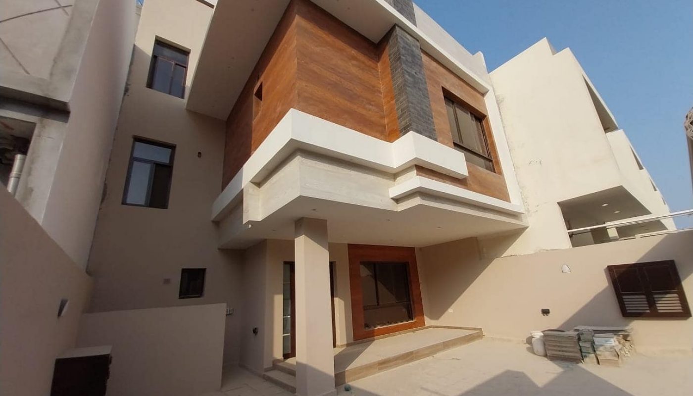 A modern villa for sale in the middle of a city with multiple bedrooms.