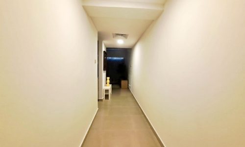 An Amwaj apartment with a white wall and a door.